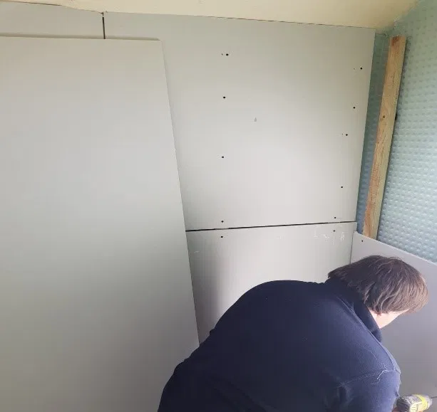 a man adding cladding