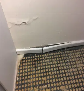 damaged floor to wall