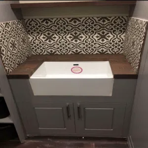basement sink with decorative tiles